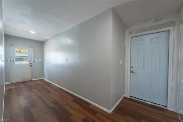 a view of room with window and wooden floor