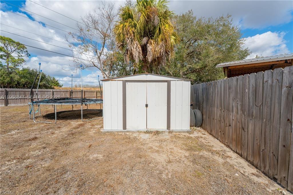 845 Quail Run LaBelle, FL 33935 - Photo 24 of 29 a view of backyard with wooden fence