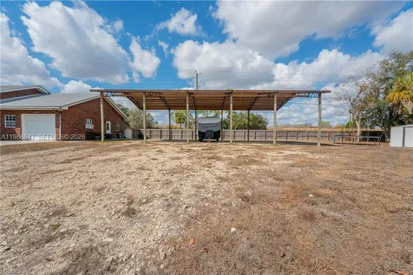 a view of a house with a big yard and large trees