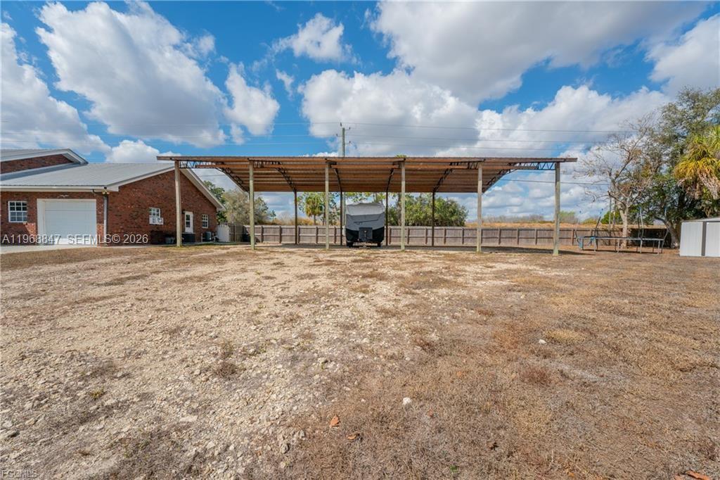 845 Quail Run LaBelle, FL 33935 - Photo 26 of 29 a view of a house with a big yard and large trees
