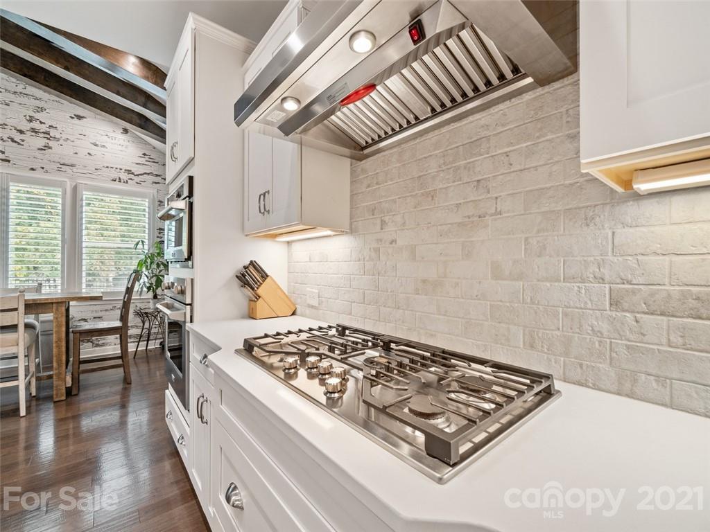 2822 Walker Road Matthews, NC 28105 - Photo 11 of 47 a kitchen with a stove a window cabinets and dining table