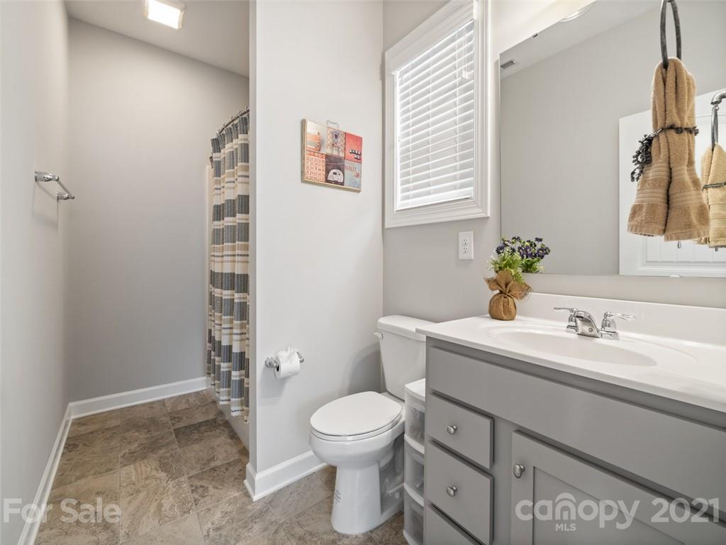 2822 Walker Road Matthews, NC 28105 - Photo 32 of 47 a bathroom with a toilet sink and a mirror