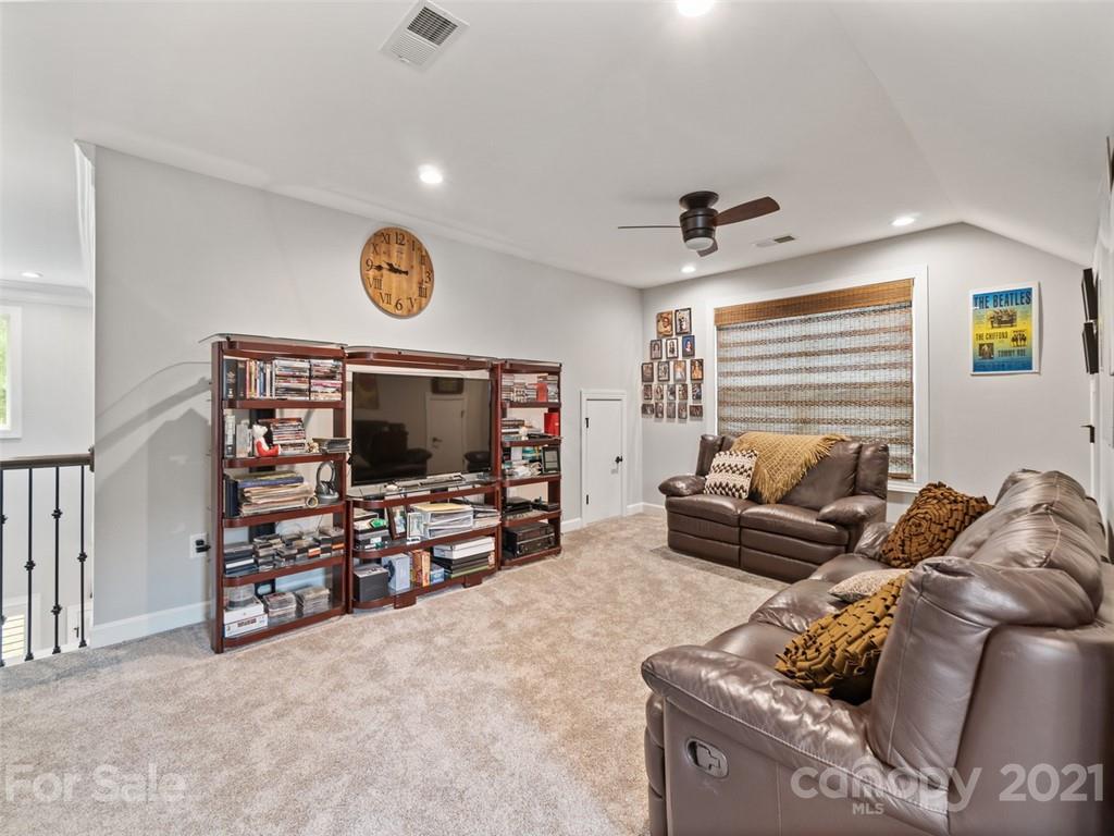 2822 Walker Road Matthews, NC 28105 - Photo 36 of 47 a living room with furniture and a flat screen tv