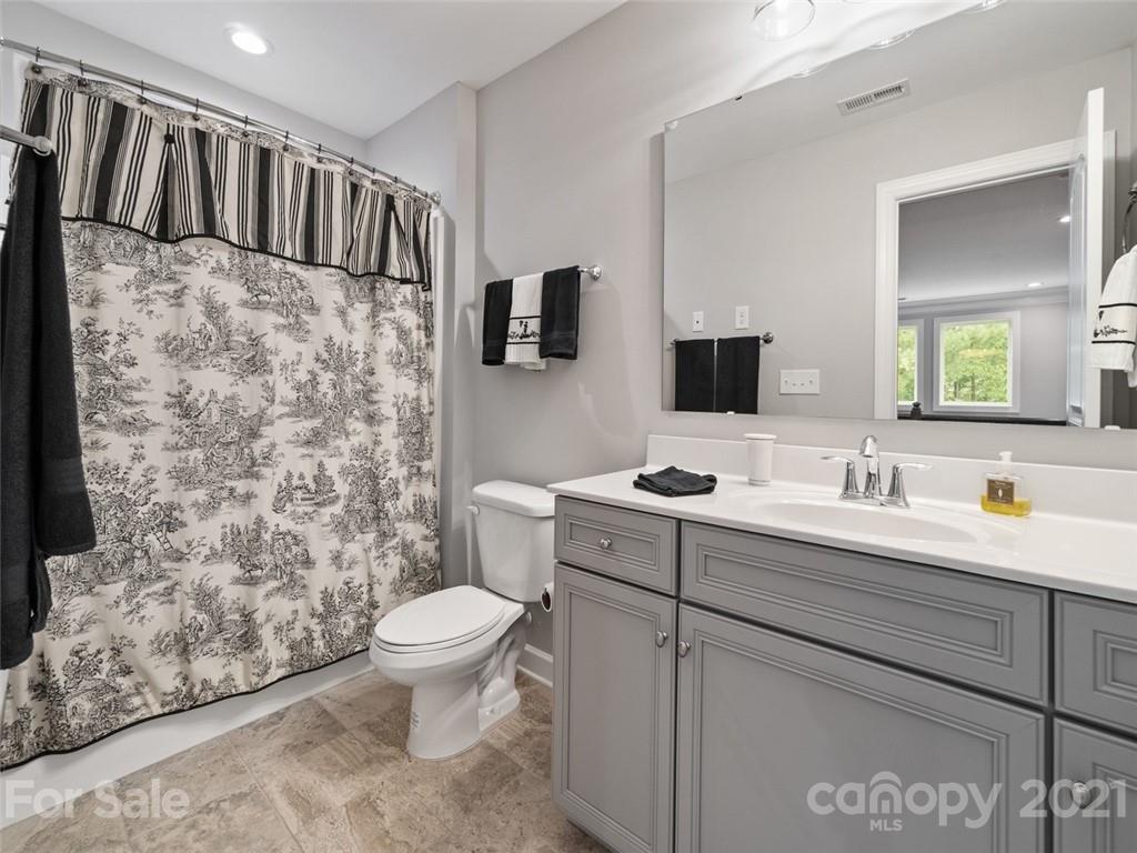 2822 Walker Road Matthews, NC 28105 - Photo 41 of 47 a bathroom with a granite countertop sink toilet and shower