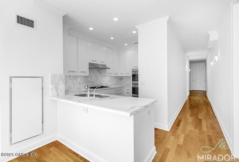 70 Forest Street, Unit 5E Stamford, CT 06901 - Photo 6 of 15 a kitchen with a sink a stove and a refrigerator
