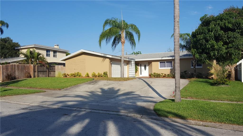 9873 Commodore Drive Seminole, FL 33776 - Photo 1 of 1 a house view with a garden space