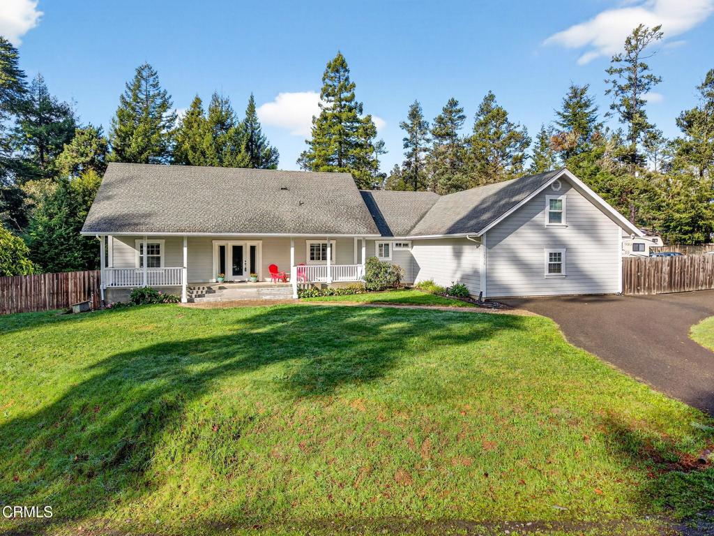 a view of house that has a yard