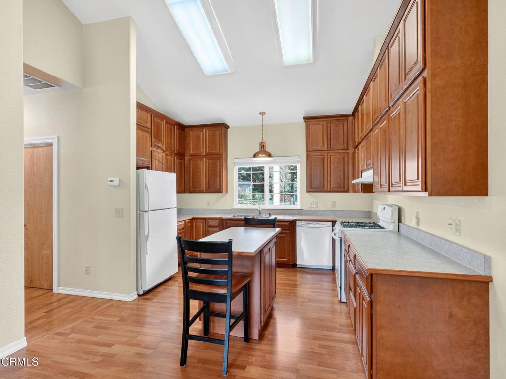 18970 Quail Lane Fort Bragg, CA 95437 - Photo 9 of 36 a kitchen with stainless steel appliances granite countertop a table chairs sink and cabinets