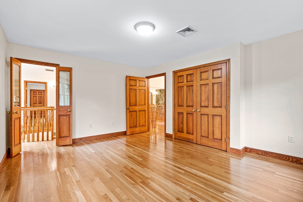 282 High Street Winchester, MA 01890 - Photo 16 of 26 a view of an empty room with wooden floor and a window