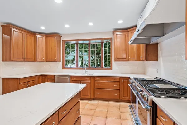 a kitchen that has a sink and a stove