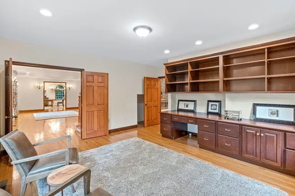 a living room with furniture and a dresser