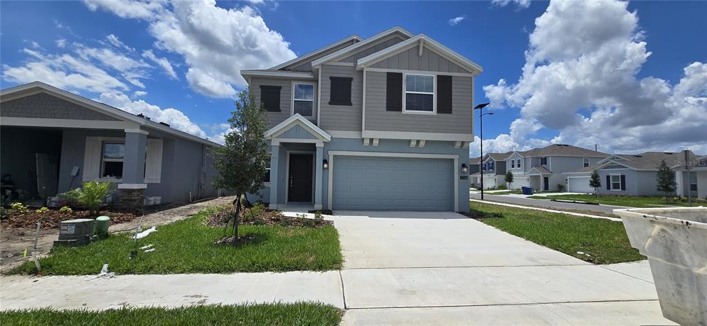 a front view of a house with a yard and garage