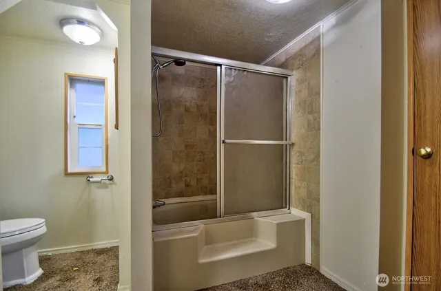 a bathroom with a toilet and shower