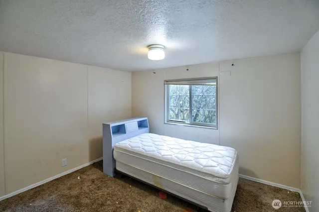 a bedroom with a bed and window