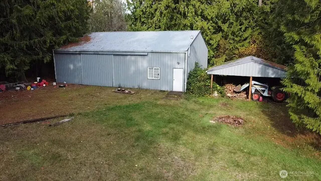 a view of a house with a patio and a yard
