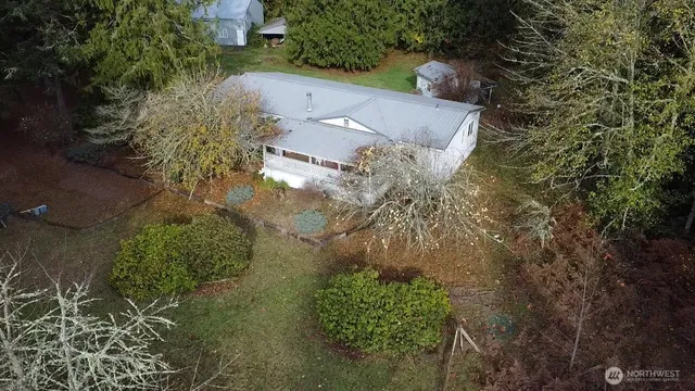 an aerial view of a house with a yard