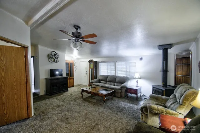 a living room with furniture and kitchen