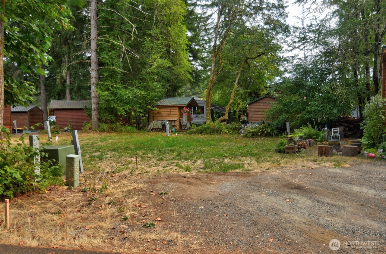 1546 Reservation Road Southeast, Unit 137 Olympia, WA 98513 - Photo 4 of 20 a backyard of a house with table and chairs
