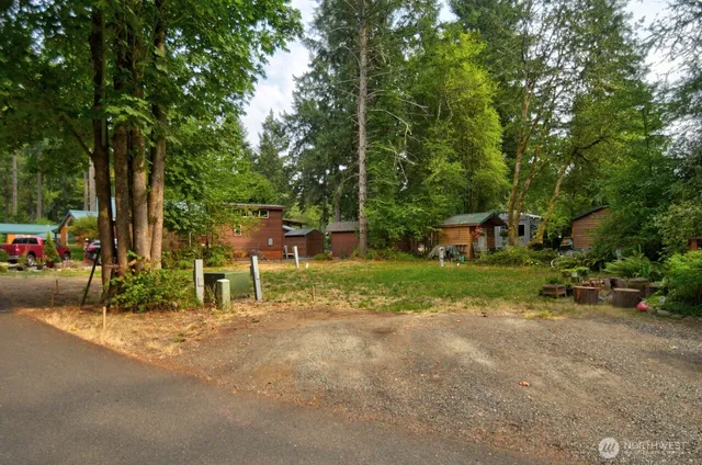 a view of a house with a yard and sitting area