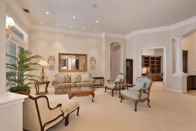 a large kitchen with stainless steel appliances a large counter top a stove a sink a refrigerator and a refrigerator