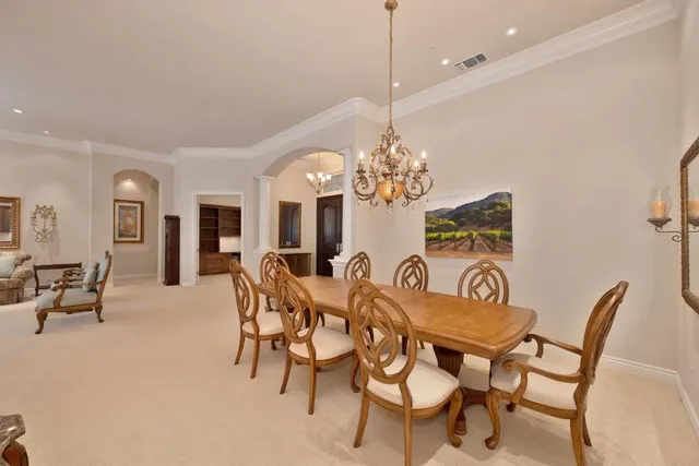 a large kitchen with a table and chairs