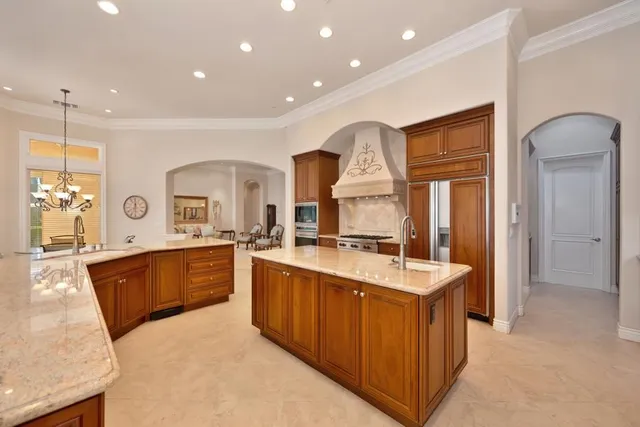 a kitchen with stainless steel appliances granite countertop a sink and cabinets