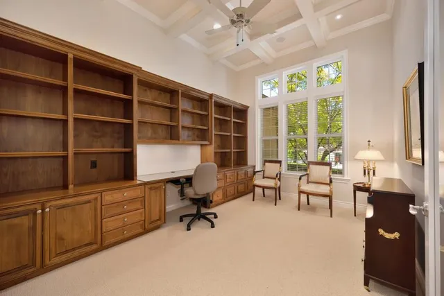 a spacious bedroom with a bed and a chandelier