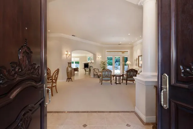 a very nice looking living room with a large window and furniture