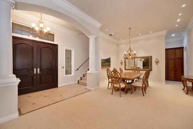 a living room with furniture and a floor to ceiling window