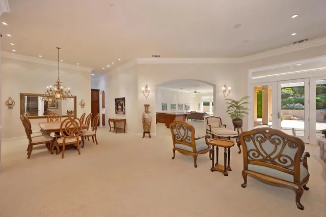 a large kitchen with kitchen island a large counter top stainless steel appliances and cabinets