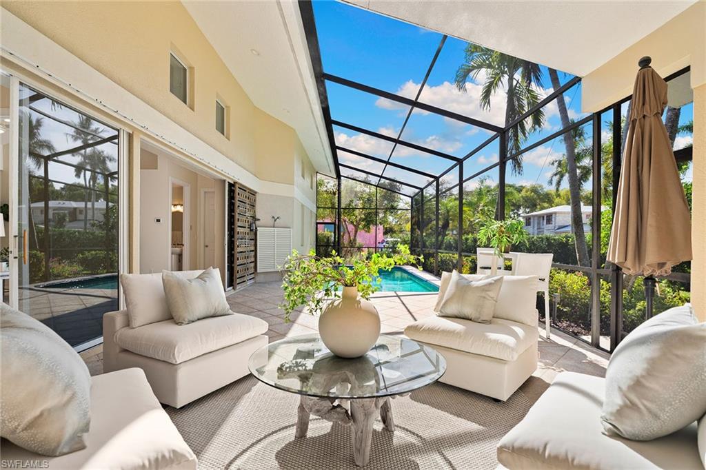 416 3rd Avenue North Naples, FL 34102 - Photo 1 of 50 a living room with furniture and a large window