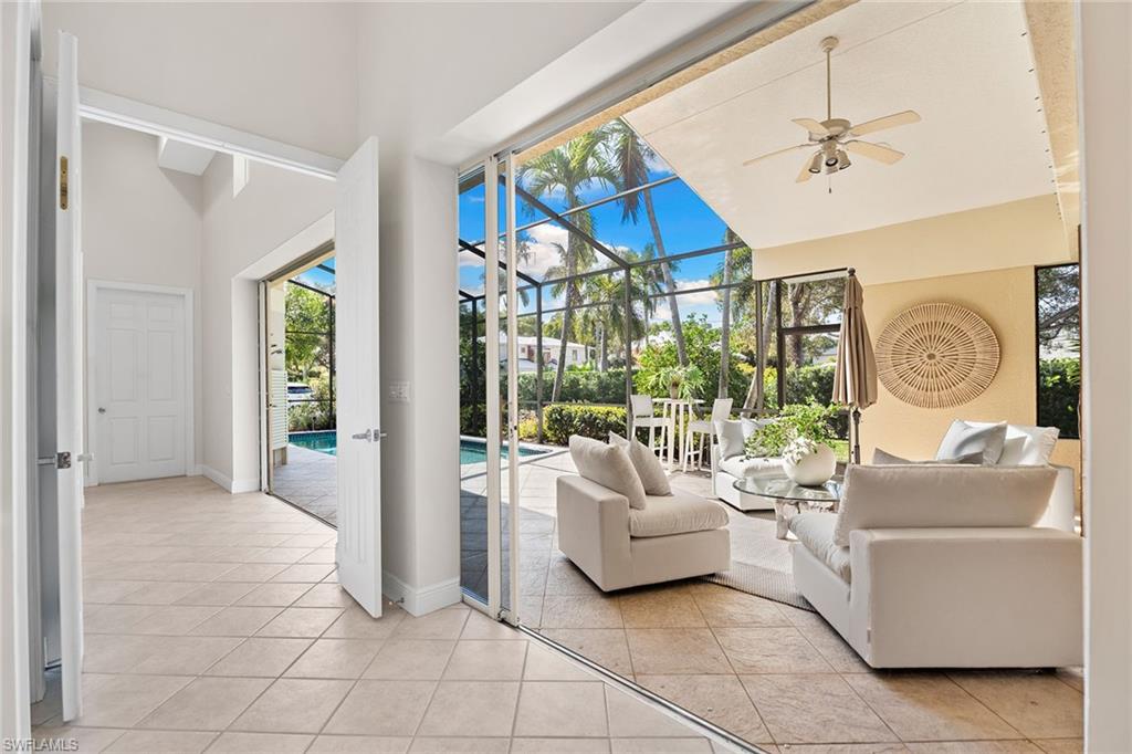 416 3rd Avenue North Naples, FL 34102 - Photo 21 of 50 a living room with furniture a chandelier and a floor to ceiling window