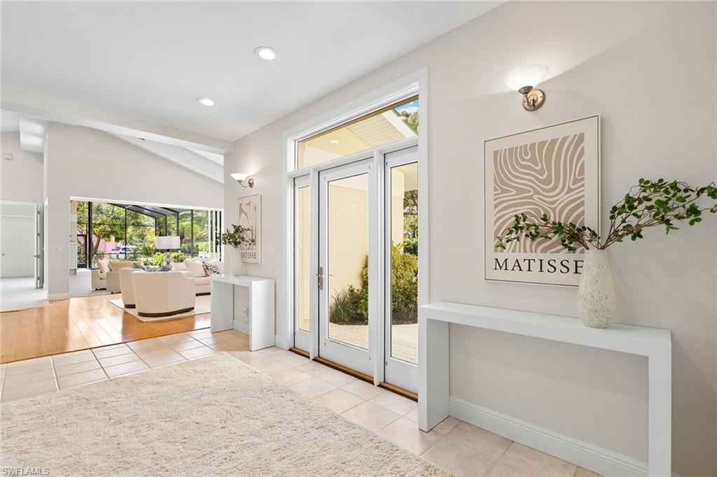 416 3rd Avenue North Naples, FL 34102 - Photo 25 of 50 a bedroom with a bed and a painting on the wall