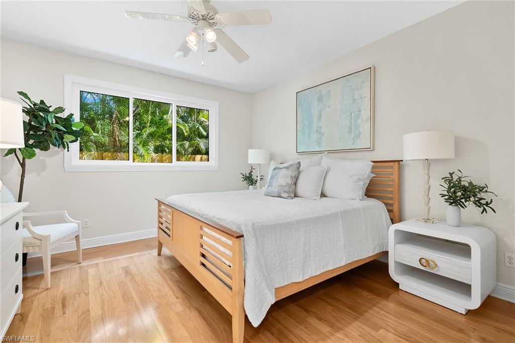 416 3rd Avenue North Naples, FL 34102 - Photo 32 of 50 a bedroom with a bed and a chair