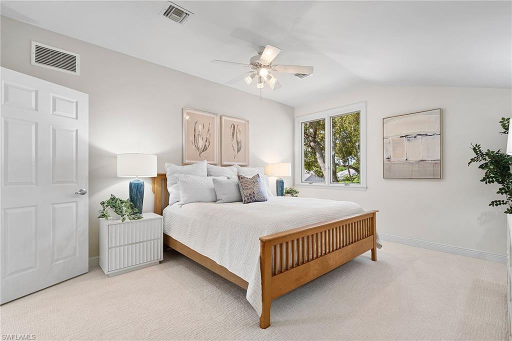 416 3rd Avenue North Naples, FL 34102 - Photo 35 of 50 a bedroom with a bed and a chandelier