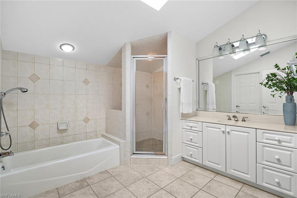 416 3rd Avenue North Naples, FL 34102 - Photo 36 of 50 a bathroom with a tub sink and mirror