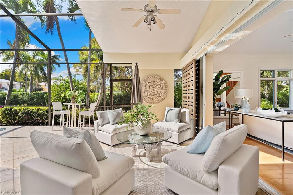 416 3rd Avenue North Naples, FL 34102 - Photo 9 of 50 a living room with furniture and a floor to ceiling window