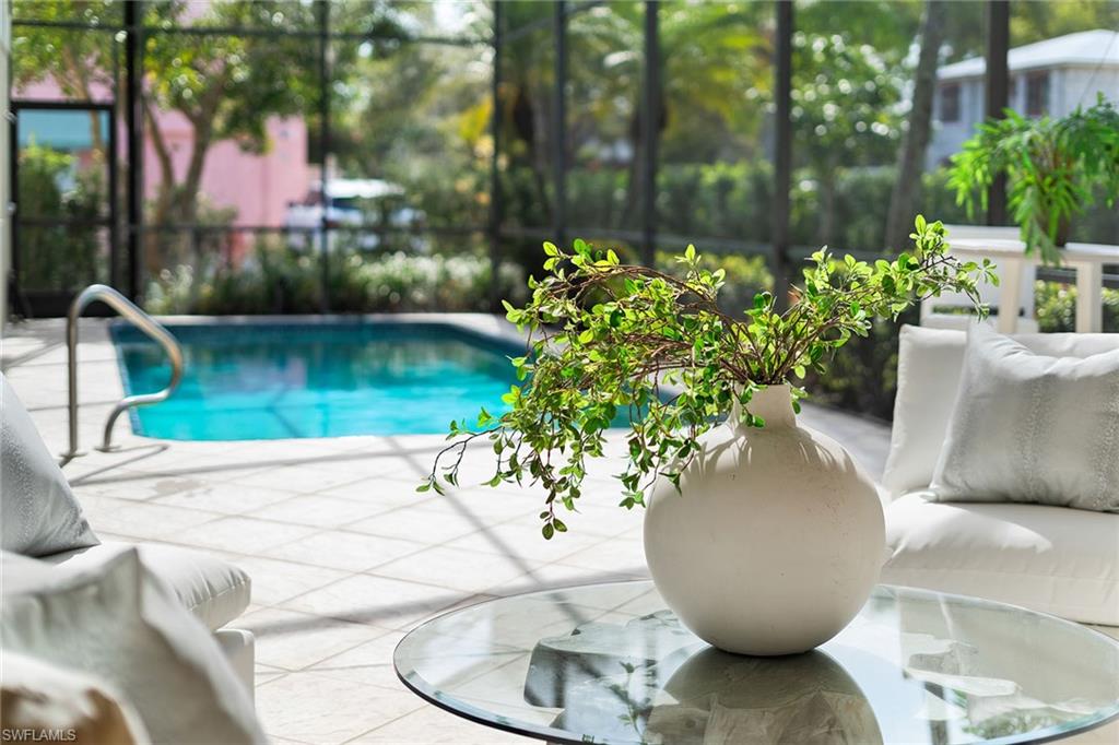 416 3rd Avenue North Naples, FL 34102 - Photo 10 of 50 a view of a vase of flowers sitting on a table