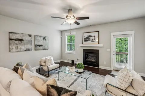 a living room with furniture a window and a fireplace