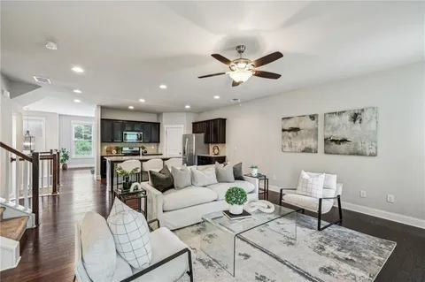 a living room with furniture and kitchen view