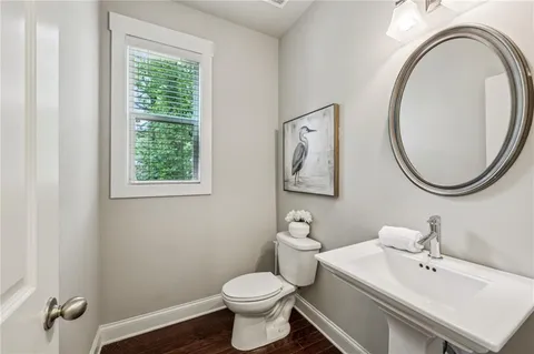 a bathroom with a sink a mirror and a toilet