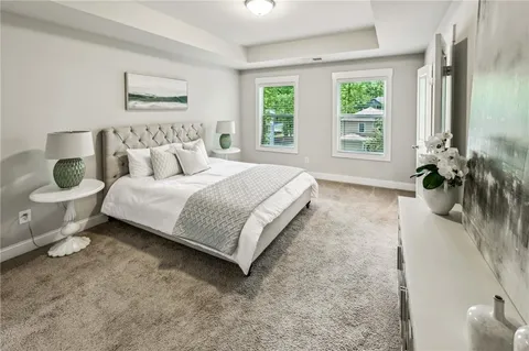 a bedroom with a bed table and a window