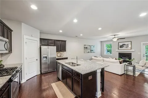 a kitchen with stainless steel appliances granite countertop a refrigerator and a stove top oven