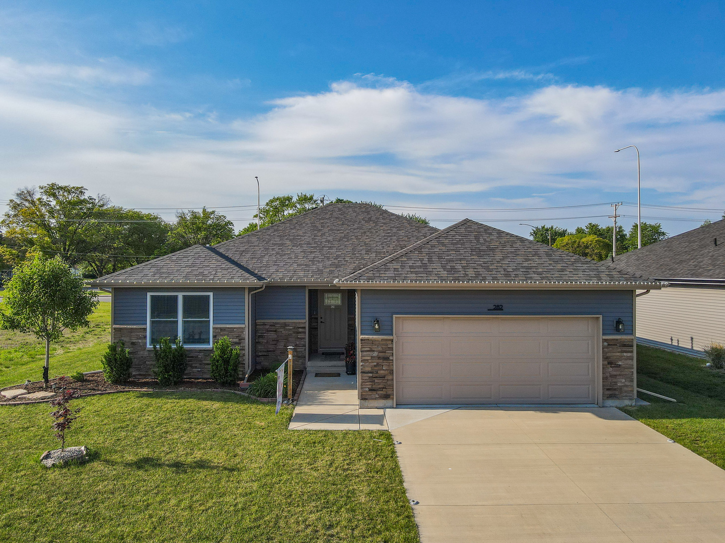 a front view of a house with a yard and garage