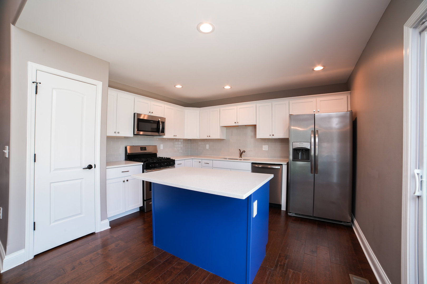 282 Patton Turn Bradley, IL 60915 - Photo 13 of 37 a kitchen with white cabinets and stainless steel appliances