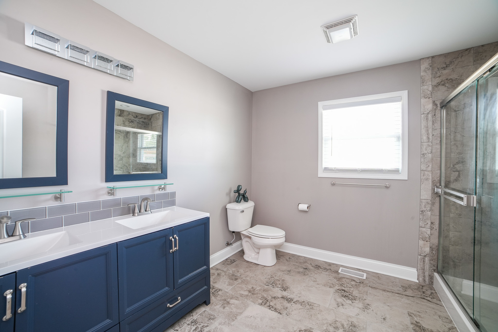 282 Patton Turn Bradley, IL 60915 - Photo 20 of 37 a bathroom with a double vanity sink a toilet and a mirror