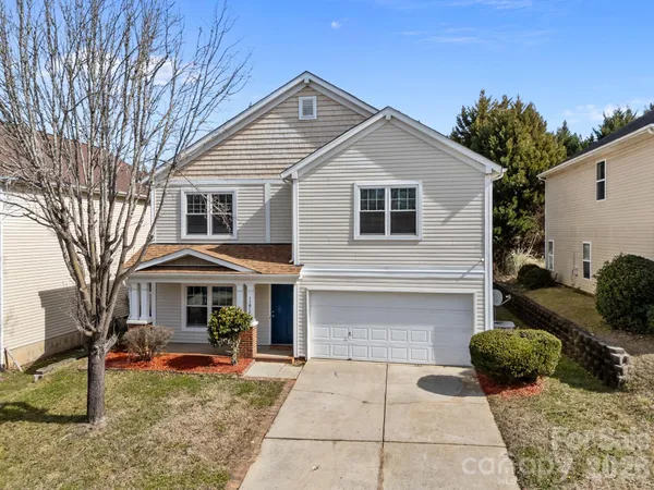 a front view of a house with yard and seating space