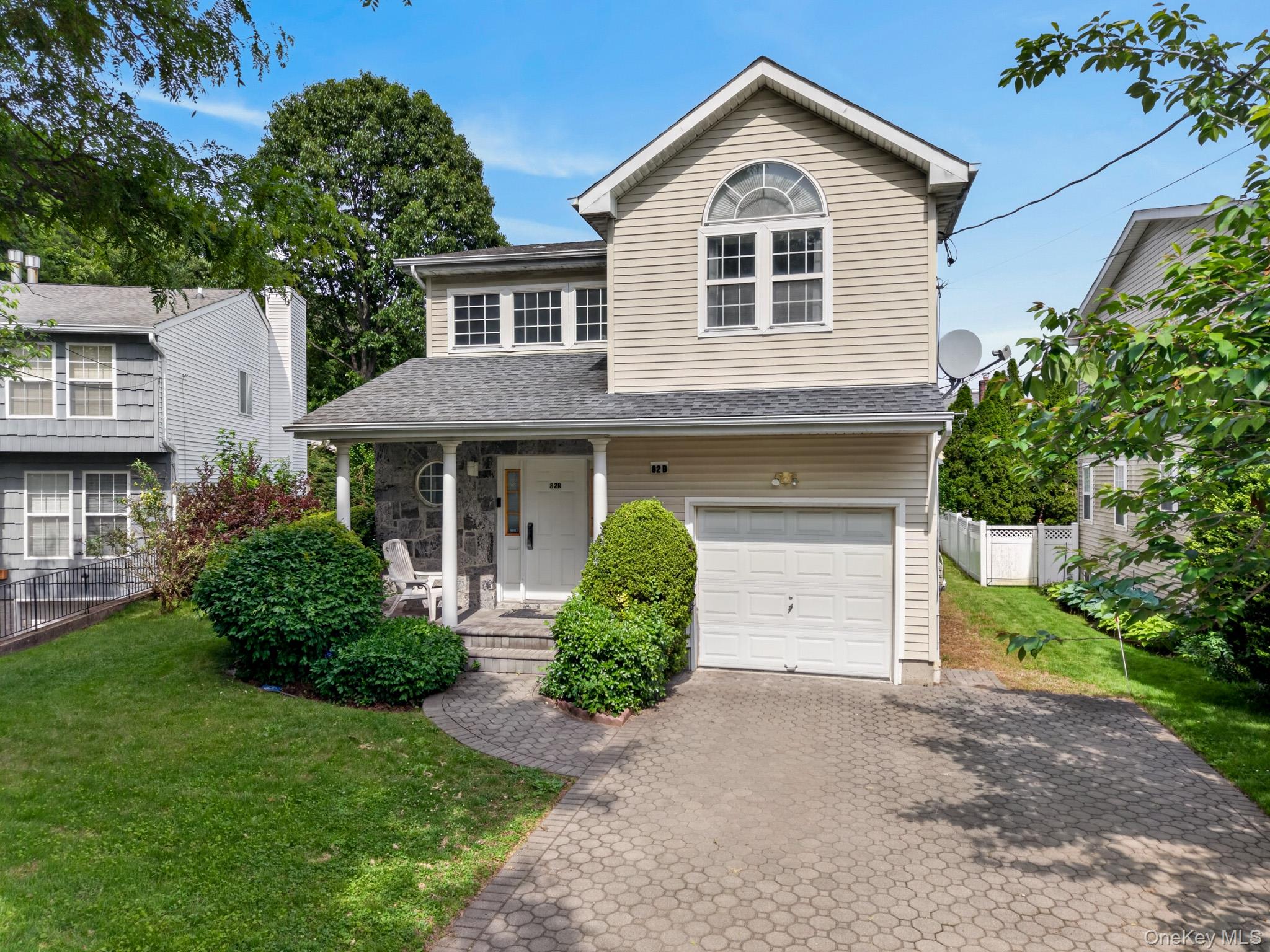 82 B Inwood Road Port Washington, NY 11050 - Photo 1 of 41 a front view of a house with a yard and garage