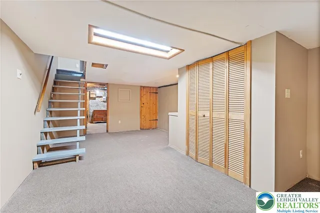 a view of room with stairs and a window