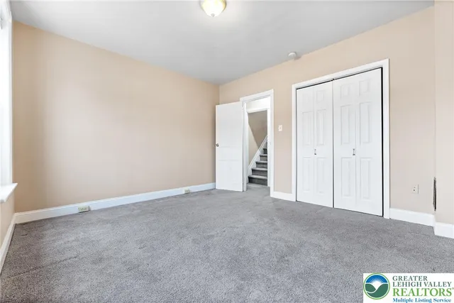 an empty room with closet area